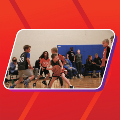 A group of kids playing indoor basketball